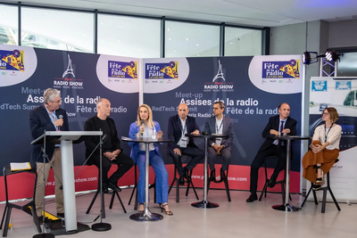 A panel of seven people on stage at Assises de la radio 