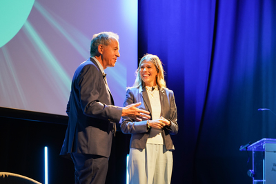 Patrick Hannon on stage at WorldDAB Automotive 2022 talking to event host Nicki Shields