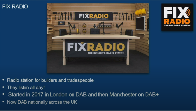 The Fix Radio studio - a desk with microphones on it, in a room with builders tools on the wall