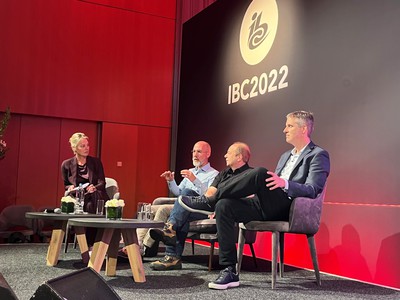 A panel of four people sitting on the stage at IBC2022