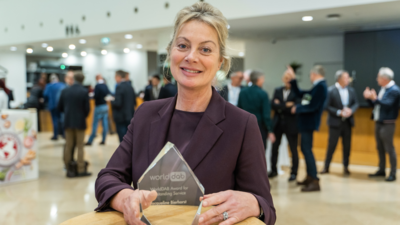Jacqueline Bierhorst holds the WorldDAB Award for Outstanding Service glass trophy
