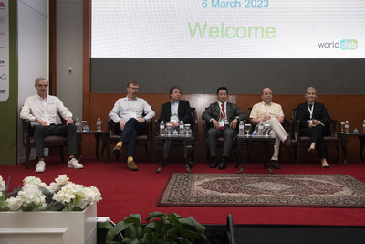 A panel of six people sat in chairs on stage at ABU DBS