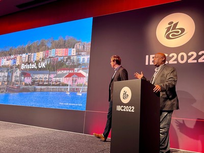 Nick Piggott (left) and Donald McTernan of Bristol Digital Radio on stage at IBC2022 in front of a screen with a picture of Bristol