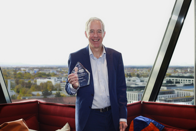 Patrick Hannon holds the WorldDAB Award for Outstanding Service glass trophy