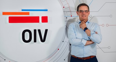 Mate Botica, CEO of OIV stands in front of a wall with an OIV logo